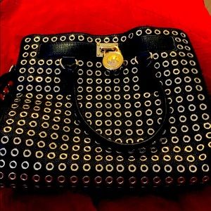 Large Michael Kors handbag with gold grommets.